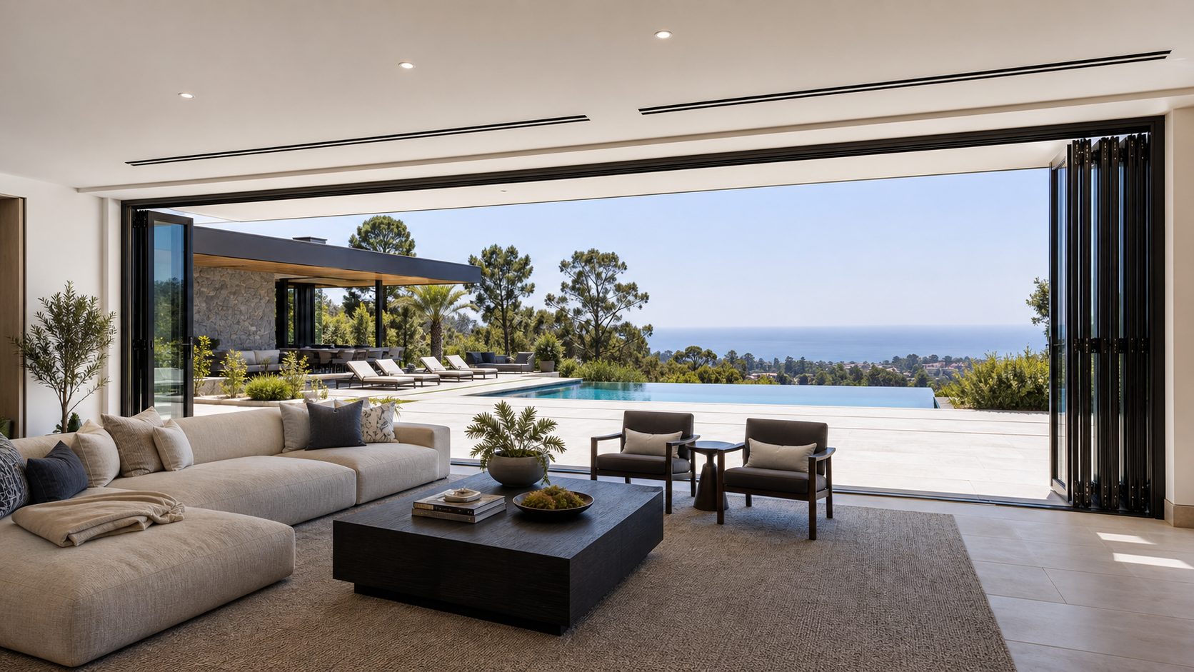 Panoramic living room opened to pool deck with folding glass walls